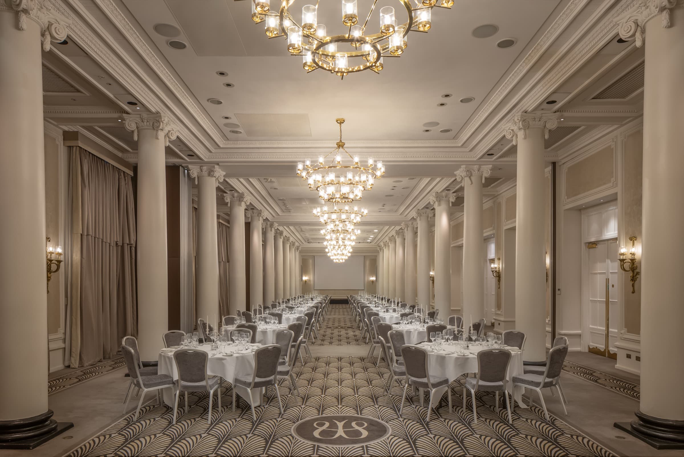 The Adelphi Suite at The Waldorf Hilton, set for dinner beneath its chandeliers