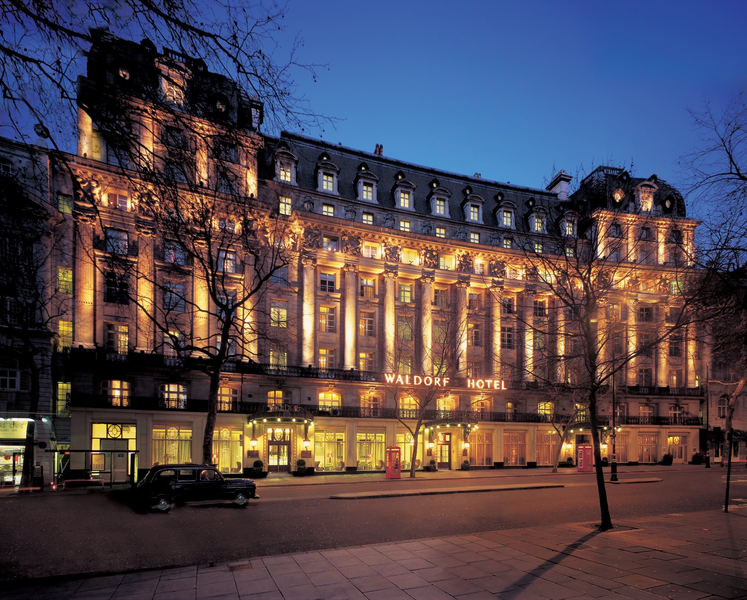 The Waldorf Hilton, London, illuminated at dusk